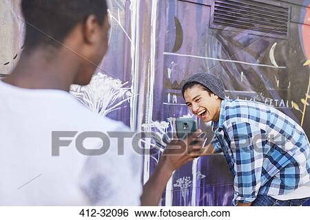 Teenage boys with cell phone laughing View Large Photo Image Stock Photograph - Teenage boys with cell phone laughing. Fotosearch
