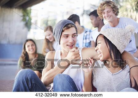 Stock Photo - Teenage couple hooking pinky fingers. Fotosearch