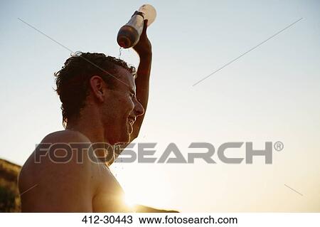 Tired runner pouring water on head View Large Photo Image Stock Image - Tired runner pouring water on head. Fotosearch