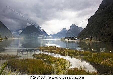 Picture - Tranquil lake and mountains, Milford Sound, South Island, New Zealand. Fotosearch