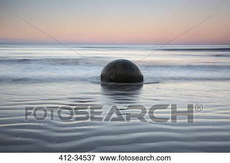 Tranquil rippling seascape and boulder, Moeraki Boulders, South Island, New Zealand View Large Photo Image Stock Photo - Tranquil rippling seascape and boulder, Moeraki Boulders, South Island, New Zealand. Fotosearch