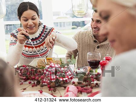 Woman cutting Christmas turkey at table View Large Photo Image Picture - Woman cutting Christmas turkey at table. Fotosearch