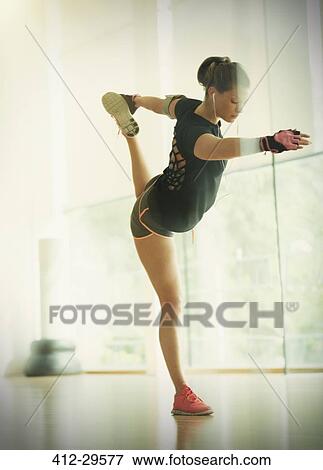 Woman holding king dancer pose in gym studio View Large Photo Image Stock Photo - Woman holding king dancer pose in gym studio. Fotosearch
