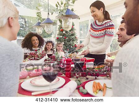 Woman serving turkey at Christmas dinner table View Large Photo Image Stock Image - Woman serving turkey at Christmas dinner table. Fotosearch