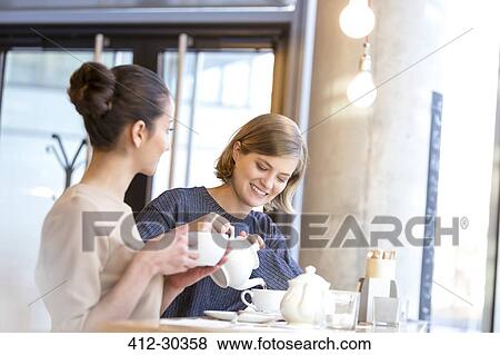 Women drinking tea in cafe View Large Photo Image Stock Photo - Women drinking tea in cafe. Fotosearch