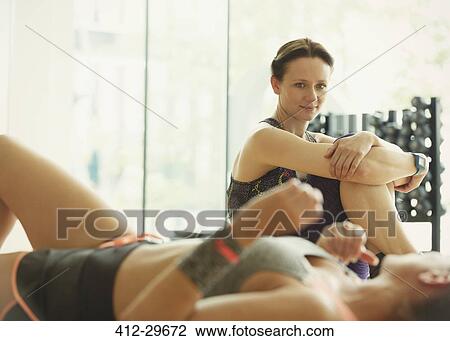 Women resting and talking at gym View Large Photo Image Stock Image - Women resting and talking at gym. Fotosearch