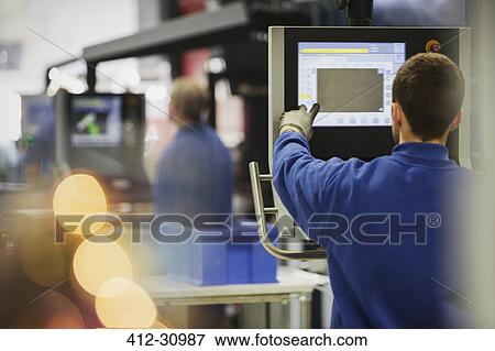 Worker at control panel in steel factory View Large Photo Image Stock Photo - Worker at control panel in steel factory. Fotosearch