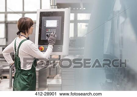 Worker at control panel operating machinery in factory View Large Photo Image Stock Image - Worker at control panel operating machinery in factory. Fotosearch