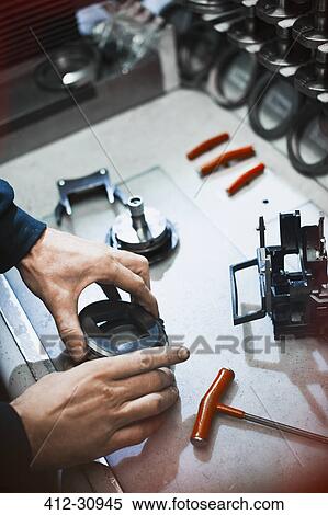 Worker examining part in steel factory View Large Photo Image Stock Photography - Worker examining part in steel factory. Fotosearch