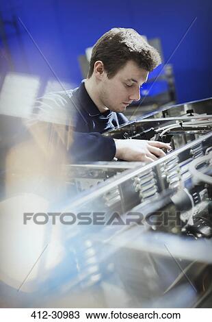Worker inspecting machinery in steel factory View Large Photo Image Stock Image - Worker inspecting machinery in steel factory. Fotosearch