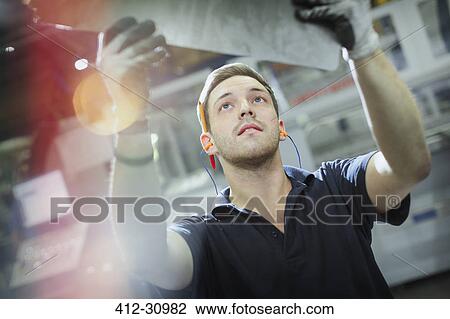 Worker inspecting steel in steel factory View Large Photo Image Stock Image - Worker inspecting steel in steel factory. Fotosearch
