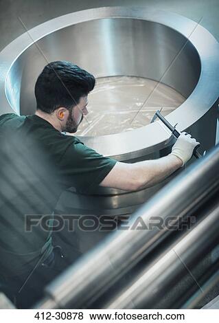 Worker measuring piece with calipers in steel factory View Large Photo Image Stock Photo - Worker measuring piece with calipers in steel factory. Fotosearch