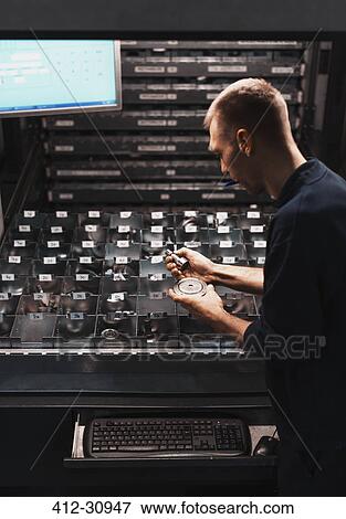 Worker searching for part in steel factory View Large Photo Image Stock Photo - Worker searching for part in steel factory. Fotosearch
