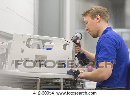 Worker using drill in steel factory View Large Photo Image Picture - Worker using drill in steel factory. Fotosearch