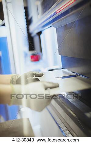 Worker using machinery in steel factory View Large Photo Image Stock Image - Worker using machinery in steel factory. Fotosearch