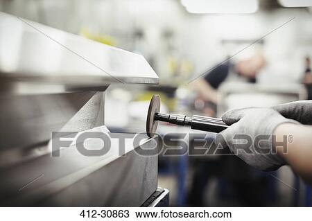 Worker using sander on steel in steel factory View Large Photo Image Stock Image - Worker using sander on steel in steel factory. Fotosearch