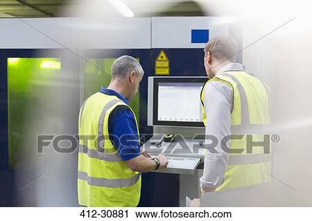 Workers at machinery control panel in steel factory View Large Photo Image Stock Image - Workers at machinery control panel in steel factory. Fotosearch