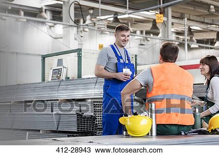Workers enjoying coffee break in steel factory View Large Photo Image Stock Image - Workers enjoying coffee break in steel factory. Fotosearch