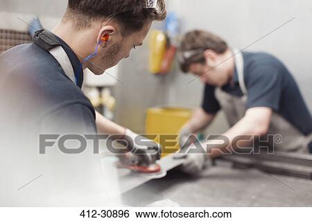 Workers sanding steel in steel factory View Large Photo Image Stock Photograph - Workers sanding steel in steel factory. Fotosearch