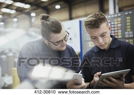 Workers with paperwork and digital tablet in steel factory View Large Photo Image Stock Image - Workers with paperwork and digital tablet in steel factory. Fotosearch