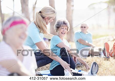 Yoga instructor guiding senior woman in sunny park View Large Photo Image Stock Photo - Yoga instructor guiding senior woman in sunny park. Fotosearch