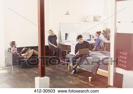 Young adult friends hanging out in loft apartment View Large Photo Image Stock Image - Young adult friends hanging out in loft apartment. Fotosearch