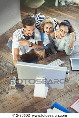 Young adult friends using computer View Large Photo Image Stock Image - Young adult friends using computer. Fotosearch