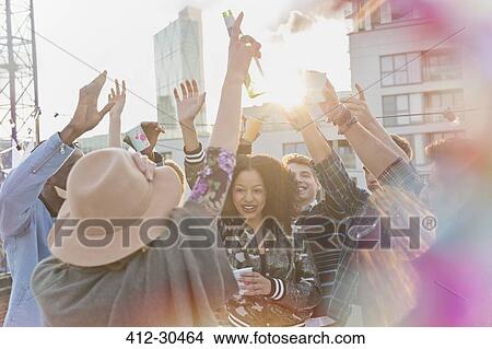Young adults dancing at rooftop party View Large Photo Image Picture - Young adults dancing at rooftop party. Fotosearch