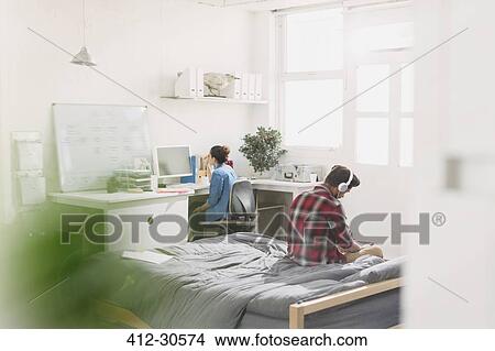 Young adults studying in apartment View Large Photo Image Picture - Young adults studying in apartment. Fotosearch