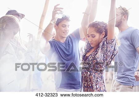 Young couple dancing at music festival View Large Photo Image Stock Image - Young couple dancing at music festival. Fotosearch