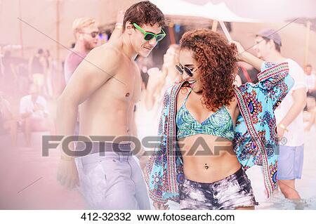 Stock Image - Young couple dancing at music festival. Fotosearch