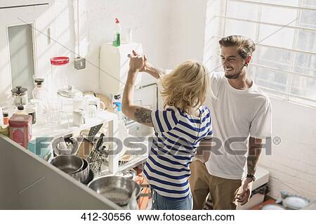 Young couple dancing in apartment kitchen View Large Photo Image Stock Photograph - Young couple dancing in apartment kitchen. Fotosearch