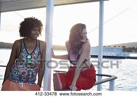 Young couple hanging out on summer houseboat View Large Photo Image Stock Photo - Young couple hanging out on summer houseboat. Fotosearch