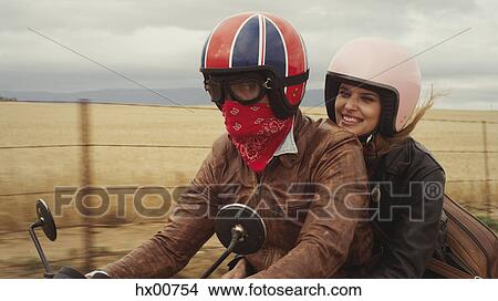 Young couple riding motorcycle in rural countryside View Large Photo Image Picture - Young couple riding motorcycle in rural countryside. Fotosearch