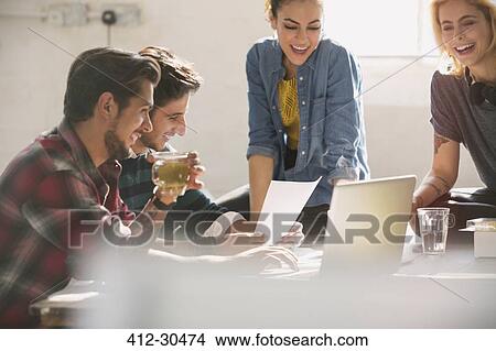 Young creative business people working at laptop View Large Photo Image Picture - Young creative business people working at laptop. Fotosearch