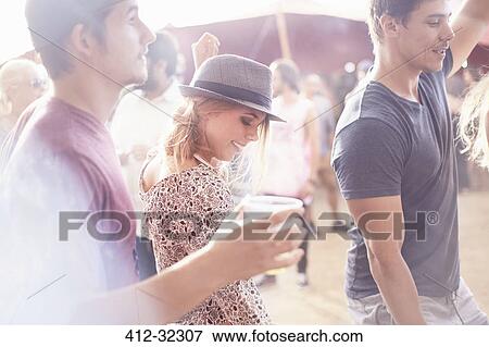 Young friends enjoying music festival View Large Photo Image Stock Photo - Young friends enjoying music festival. Fotosearch