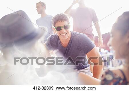 Young friends hanging out talking at music festival View Large Photo Image Stock Photo - Young friends hanging out talking at music festival. Fotosearch