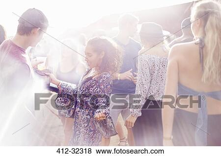 Stock Photo - Young woman dancing at music festival. Fotosearch