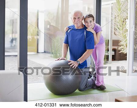 Girl hugging grandfather on exercise ball View Large Photo Image Stock Image - Girl hugging grandfather on exercise ball. Fotosearch