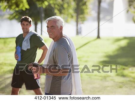 Stock Photography - Men drinking water after workout. Fotosearch