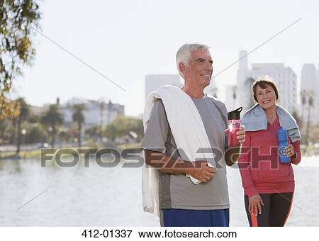 Older couple drinking water after workout View Large Photo Image Stock Photo - Older couple drinking water after workout. Fotosearch