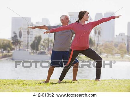 Older couple practicing yoga outdoors View Large Photo Image Stock Image - Older couple practicing yoga outdoors. Fotosearch
