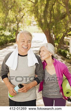Stock Photo - Older couple walking together outdoors. Fotosearch