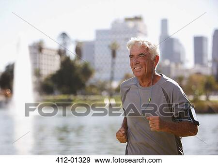 Older man jogging outdoors View Large Photo Image Stock Photo - Older man jogging outdoors. Fotosearch