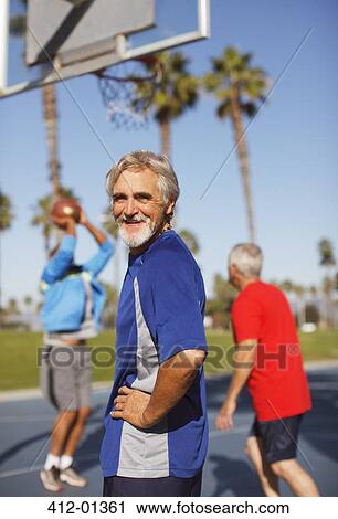 Older man playing basketball on court View Large Photo Image Stock Image - Older man playing basketball on court. Fotosearch