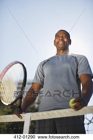 Older man playing tennis on court View Large Photo Image Stock Image - Older man playing tennis on court. Fotosearch