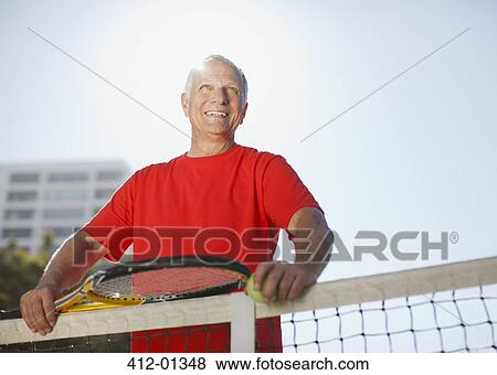Older man playing tennis on court View Large Photo Image Stock Photo - Older man playing tennis on court. Fotosearch