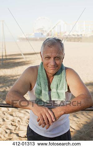 Older man relaxing after workout on beach View Large Photo Image Stock Image - Older man relaxing after workout on beach. Fotosearch