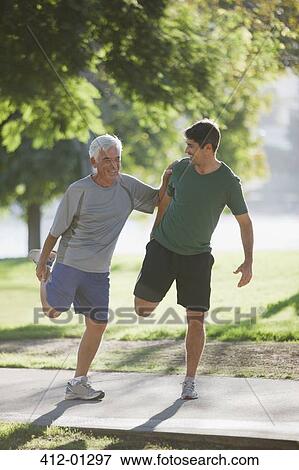 Older man stretching with trainer View Large Photo Image Stock Photo - Older man stretching with trainer. Fotosearch