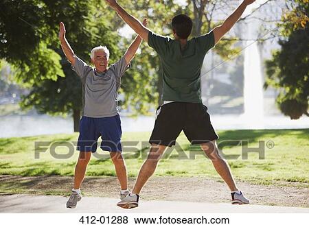 Older men doing jumping jacks outdoors View Large Photo Image Stock Photo - Older men doing jumping jacks outdoors. Fotosearch